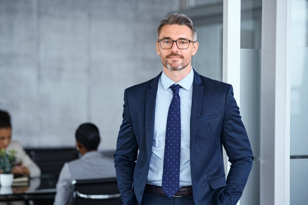 mid adult business man standing in modern office