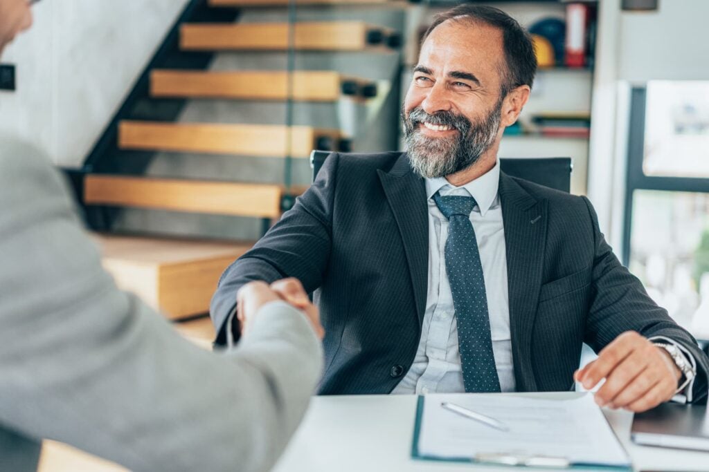 To men shake hands in interview