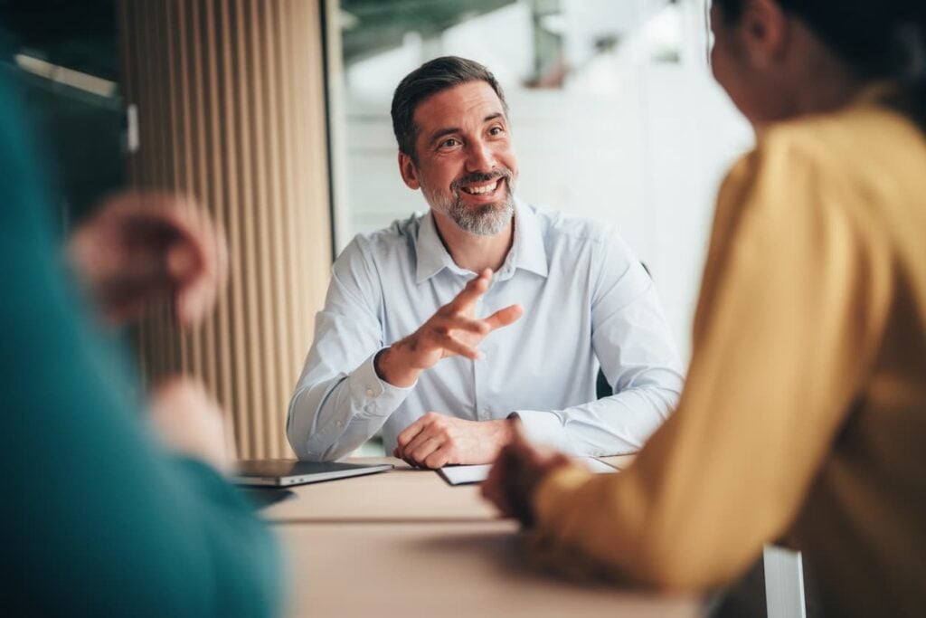 Business leader discussing finance leadership hiring decisions with team members in a meeting