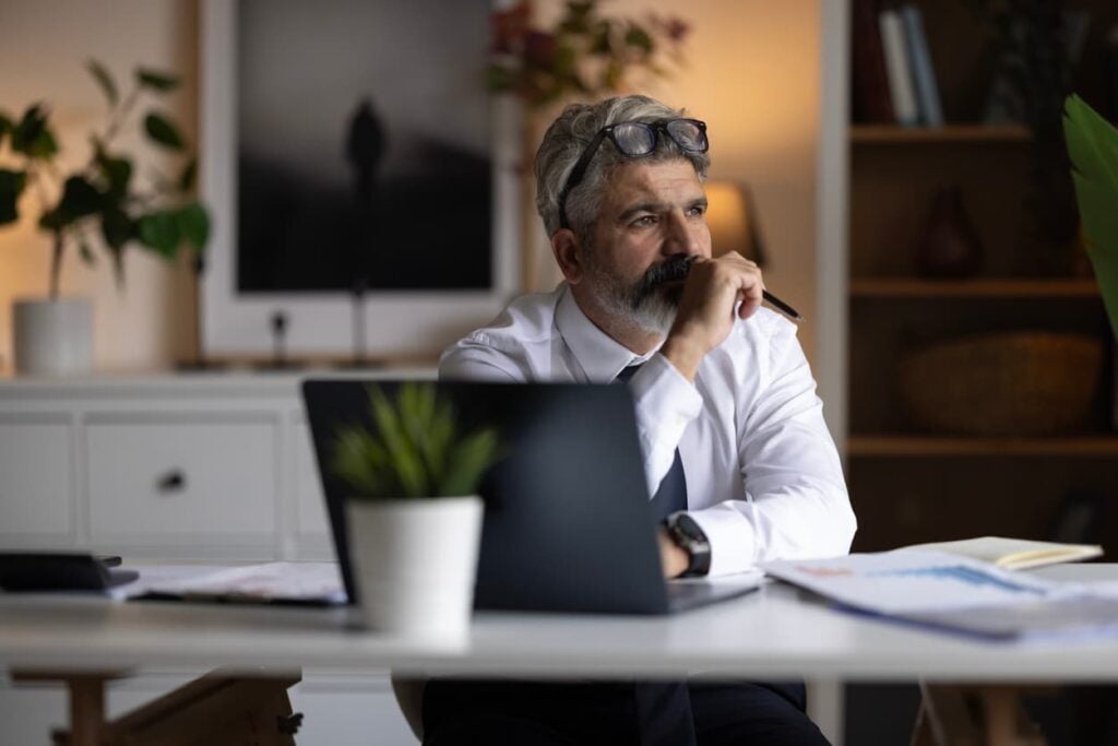 business leader sitting in office thinking