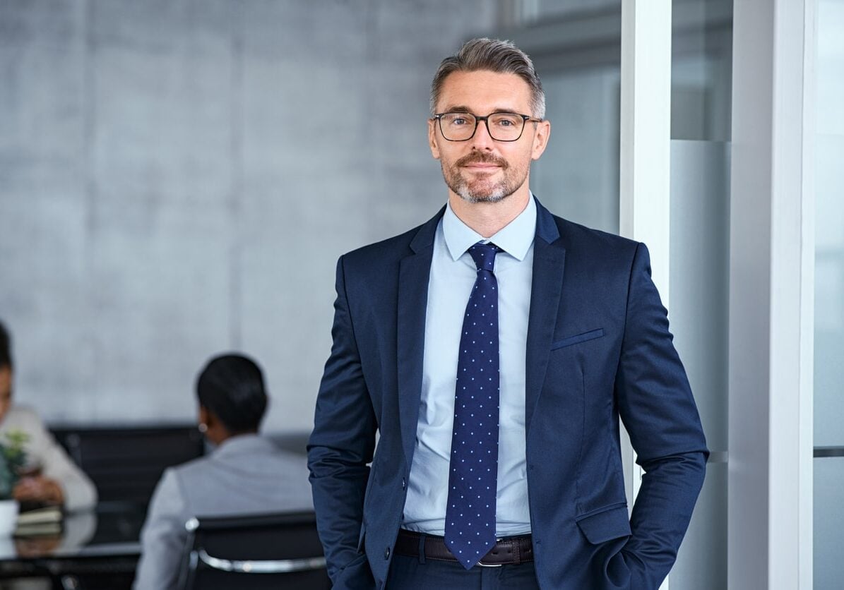mid adult business man standing in modern office