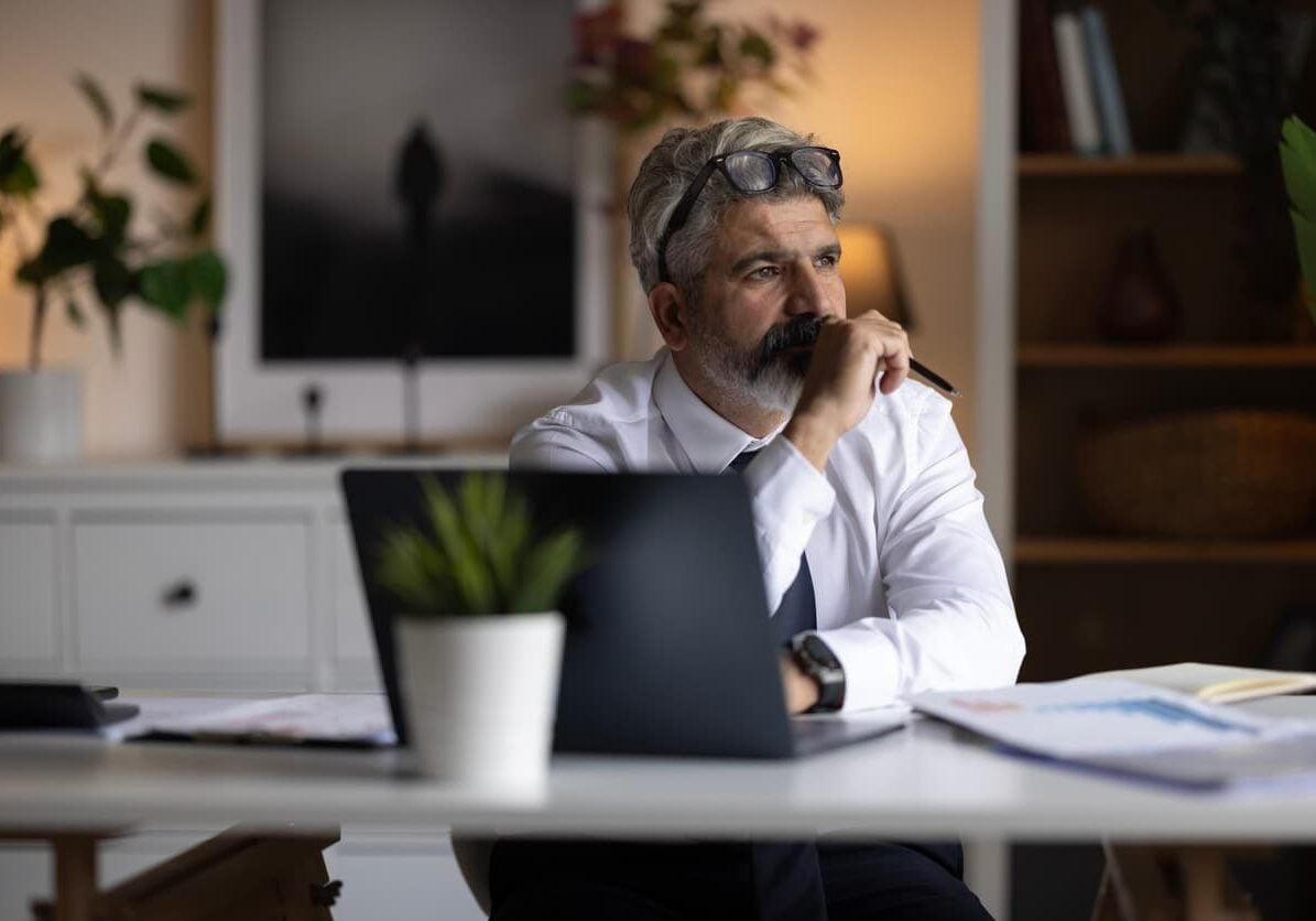 business leader sitting in office thinking