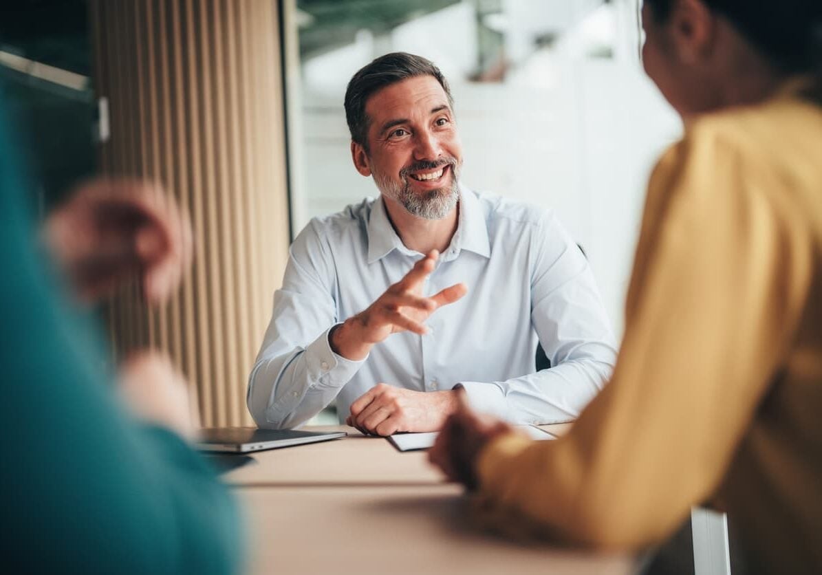 Business leader discussing finance leadership hiring decisions with team members in a meeting